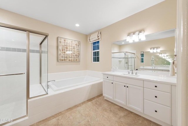 bathroom with vanity and independent shower and bath