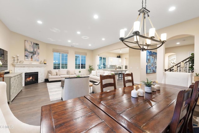 dining space featuring hardwood / wood-style flooring and a chandelier