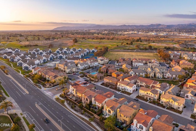 aerial view at dusk featuring a mountain view