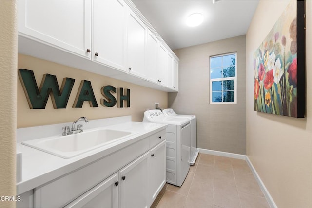 laundry area with cabinets, sink, washer and dryer, and light tile patterned floors