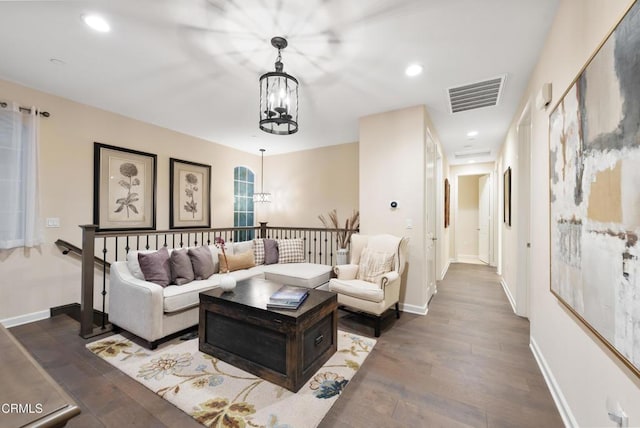 living room featuring dark hardwood / wood-style floors and a chandelier