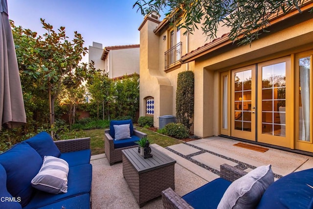 view of patio / terrace featuring an outdoor hangout area, central AC unit, and french doors