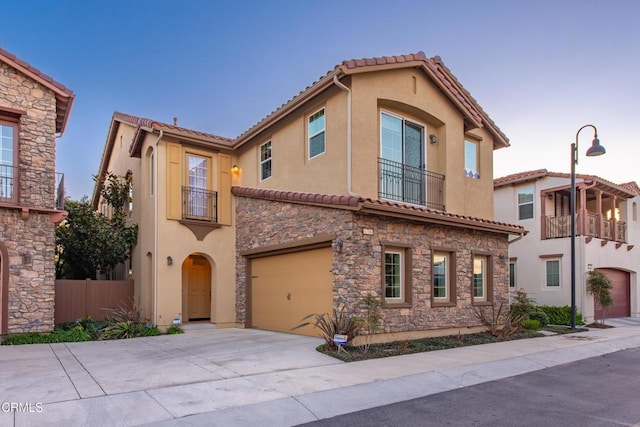 mediterranean / spanish-style house with a garage