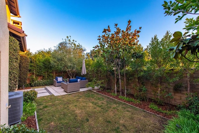 view of yard with central AC, outdoor lounge area, and a patio area