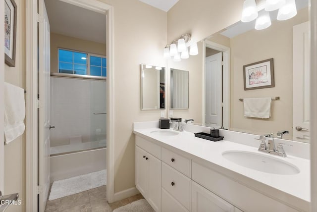 bathroom featuring tile patterned floors, vanity, and bath / shower combo with glass door