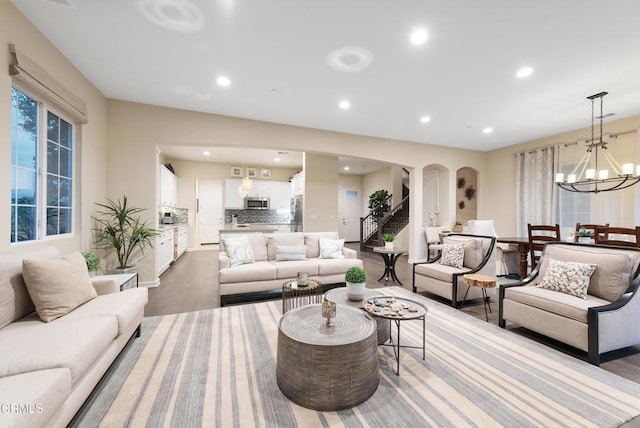 living room with dark wood-type flooring and a chandelier