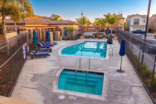 view of pool featuring a community hot tub and a patio area