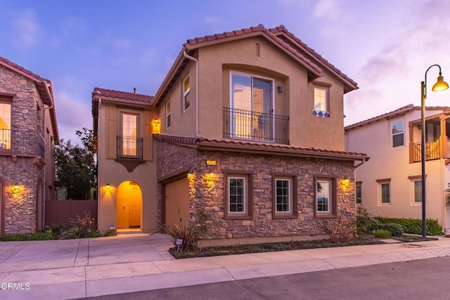 mediterranean / spanish-style house featuring a balcony