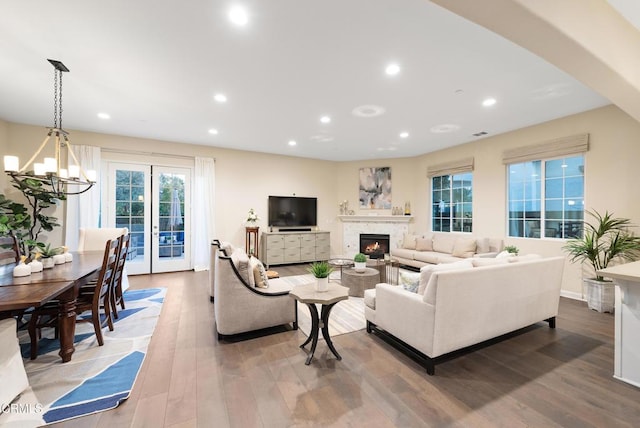 living room featuring hardwood / wood-style floors and an inviting chandelier