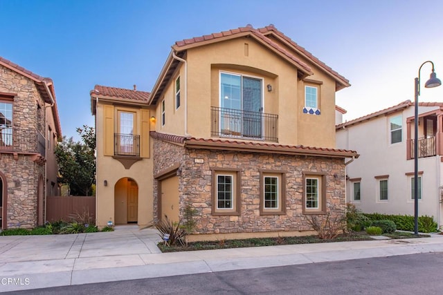 mediterranean / spanish-style home with a balcony