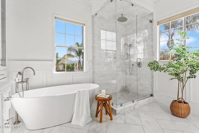 bathroom featuring separate shower and tub and a wealth of natural light