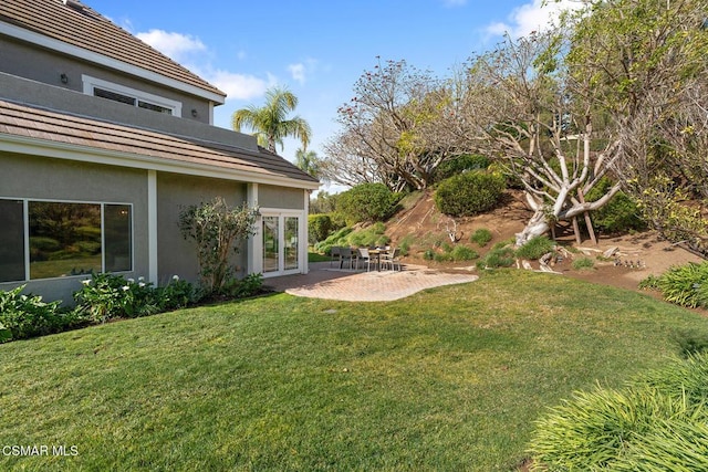 view of yard with french doors and a patio area