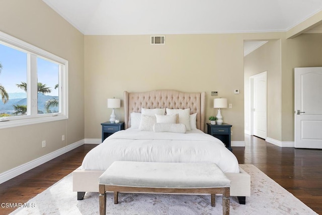 bedroom with ornamental molding, vaulted ceiling, and dark hardwood / wood-style floors