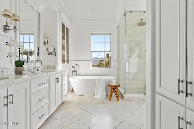 bathroom with vanity, crown molding, and separate shower and tub