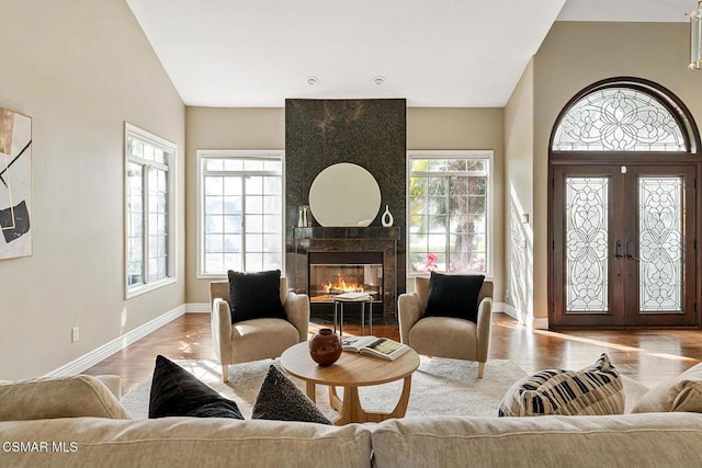 interior space featuring a fireplace, french doors, and light wood-type flooring