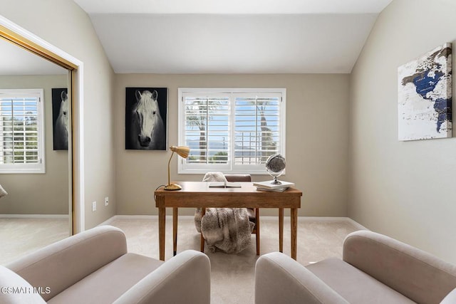 home office featuring a wealth of natural light, vaulted ceiling, and carpet