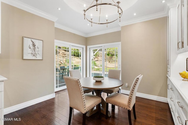 dining room featuring an inviting chandelier, ornamental molding, and dark hardwood / wood-style floors