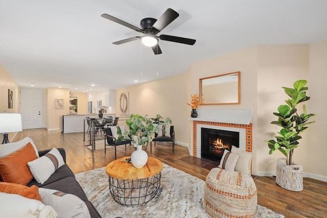 living room featuring hardwood / wood-style floors and ceiling fan