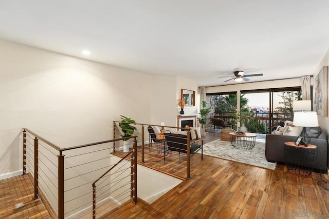 living room featuring hardwood / wood-style floors and ceiling fan