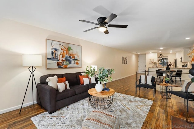 living room featuring dark hardwood / wood-style floors and ceiling fan