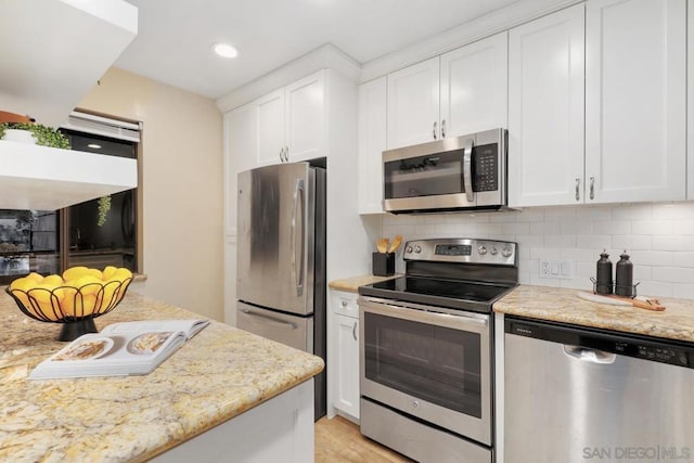 kitchen with white cabinetry, tasteful backsplash, and appliances with stainless steel finishes