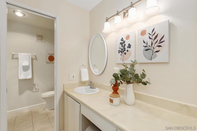 bathroom featuring vanity, tile patterned floors, and toilet