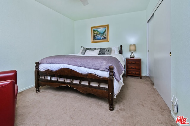 bedroom featuring light colored carpet and ceiling fan