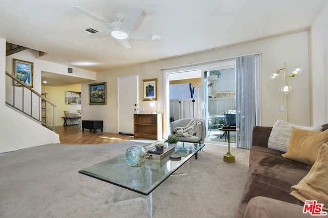 living room featuring carpet floors and ceiling fan