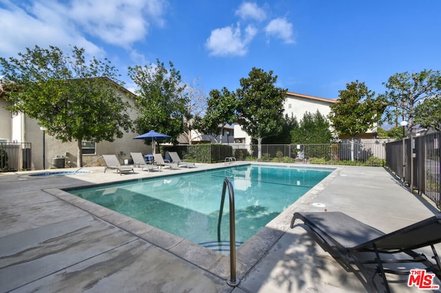 view of swimming pool featuring a patio area