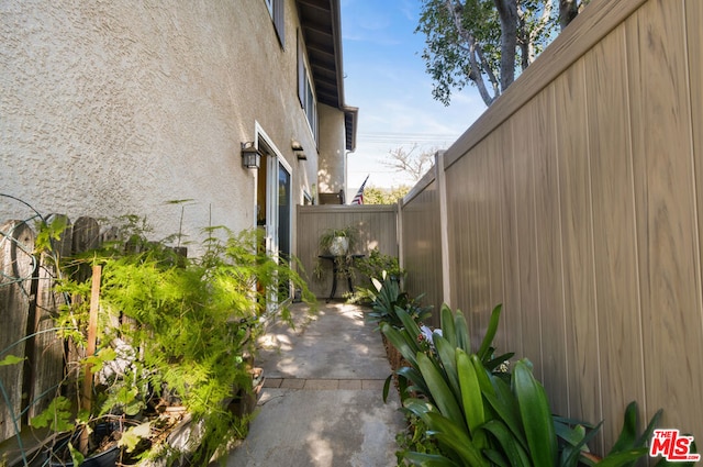 view of side of property with a patio area