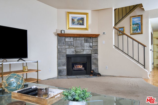 carpeted living room with a fireplace