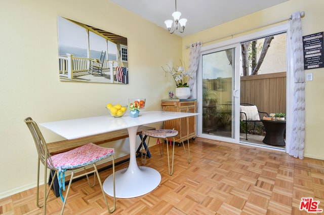 dining room featuring light parquet flooring and a notable chandelier