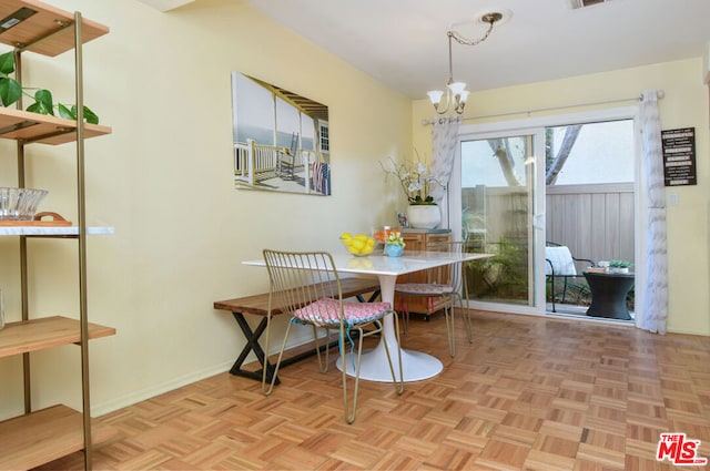 dining space featuring an inviting chandelier and light parquet floors