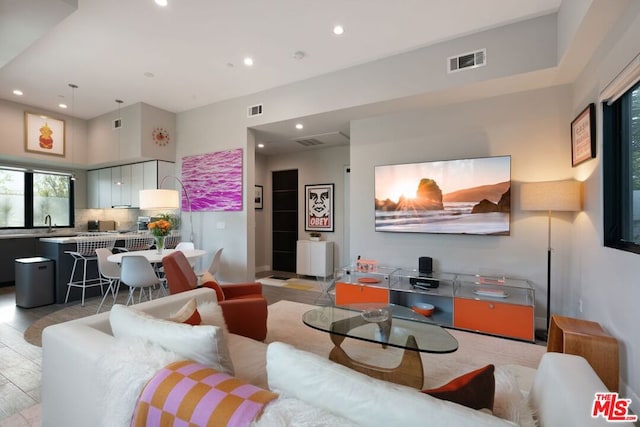 living room featuring sink and a high ceiling