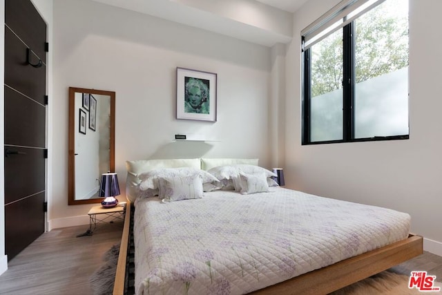 bedroom with wood-type flooring