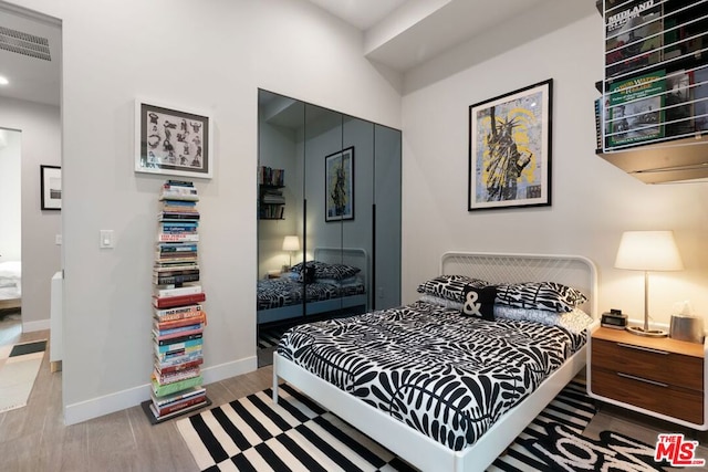 bedroom with a closet and light wood-type flooring