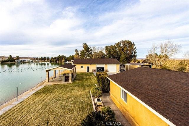 view of front of property featuring a front lawn, a water view, a gazebo, and a patio area