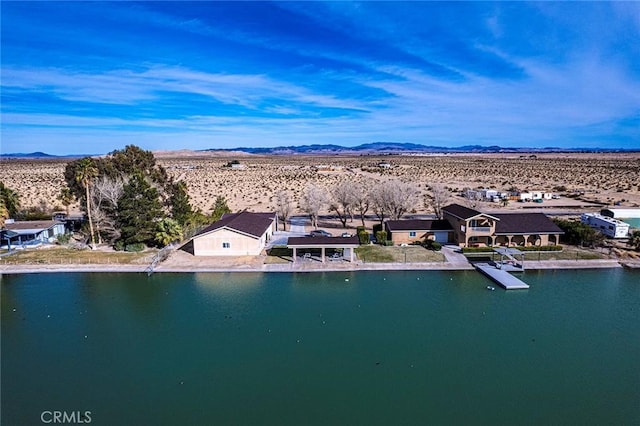 birds eye view of property featuring a water and mountain view