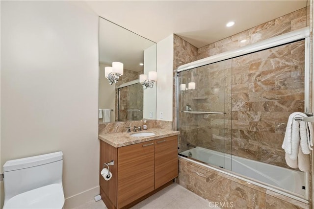 full bathroom featuring bath / shower combo with glass door, vanity, and toilet