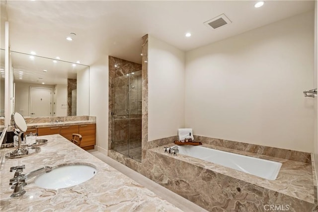 bathroom with shower with separate bathtub and vanity