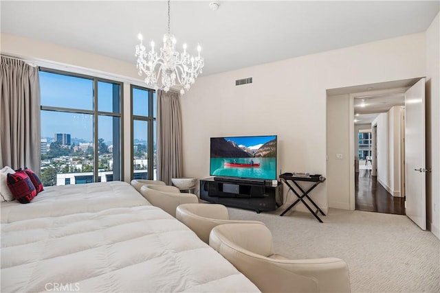 carpeted bedroom featuring a notable chandelier