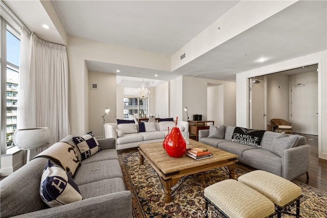 living room with wood-type flooring and a chandelier