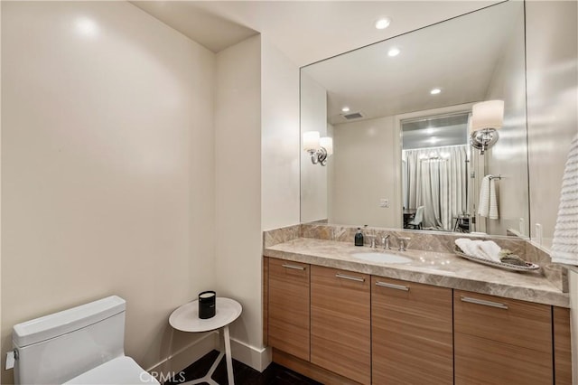 bathroom with vanity and toilet