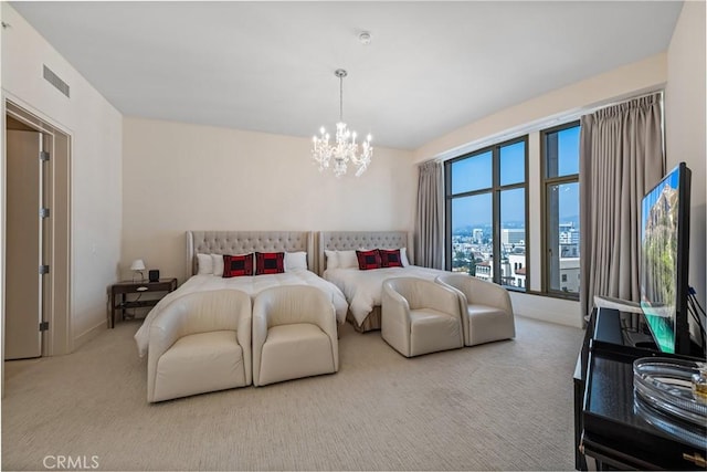 bedroom featuring a notable chandelier and light colored carpet