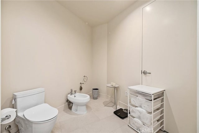 bathroom with a bidet, tile patterned floors, and toilet