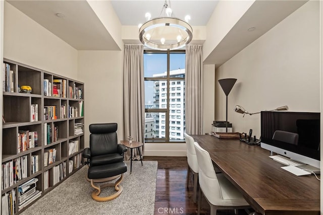 office area with an inviting chandelier and dark wood-type flooring