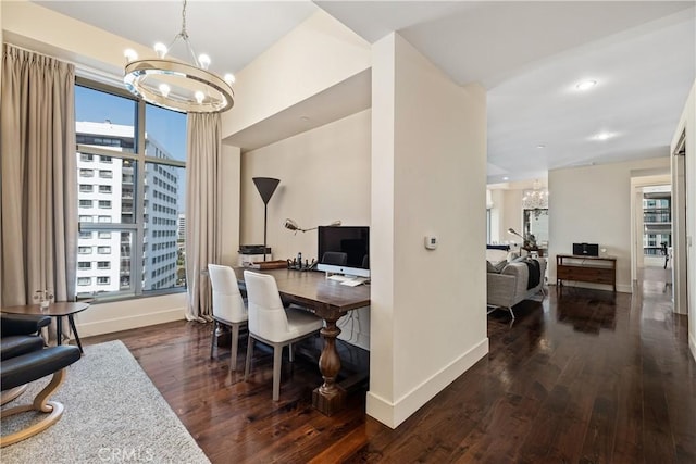 dining room featuring a notable chandelier and dark hardwood / wood-style flooring