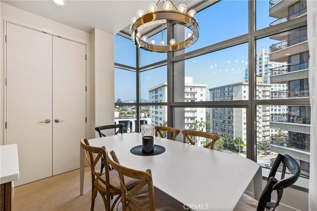 dining space with expansive windows and an inviting chandelier