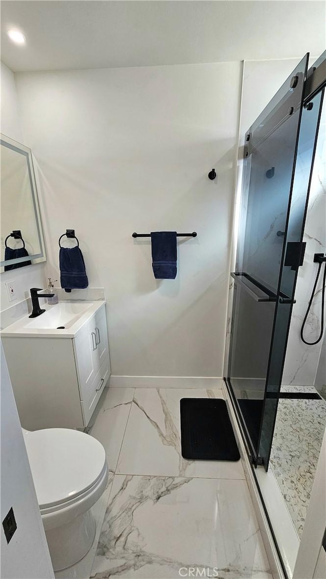 bathroom featuring vanity, toilet, and an enclosed shower