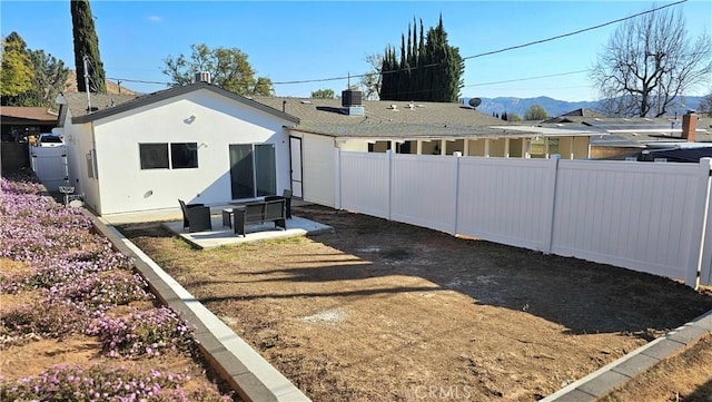 view of yard with central AC unit, a mountain view, and a patio